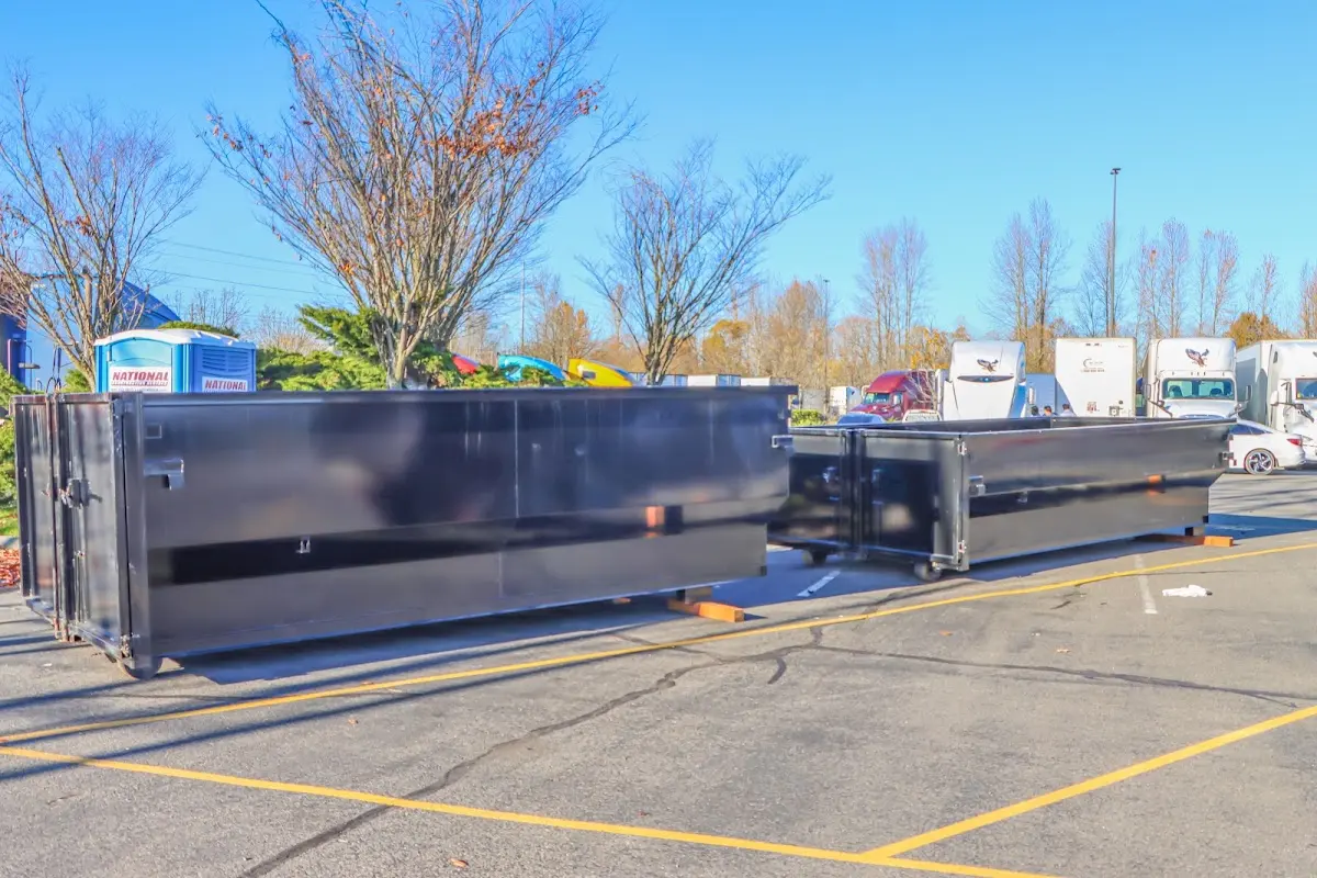 Professional dumpster rental service with roll-off container on residential driveway in Teaneck